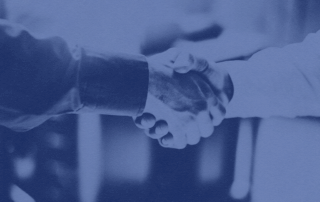 A photo of two hands shaking to make a deal.