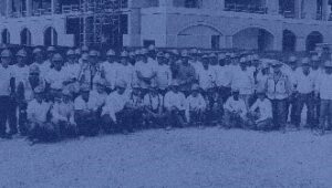 A photo of a group of crew members standing shoulder to shoulder looking at the camera.