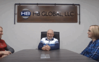 A photo of Bob, Joe, and Stacy in a conference room recording the podcast.