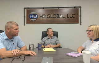 A picture of Bob, Adam, and Stacy (left to right) sitting in a conference room together talking on the podcast.