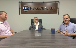 A photo of Bob Whalen, Stacy Baum, and Adam Smith (left to right) sitting in a conference room for the podcast.